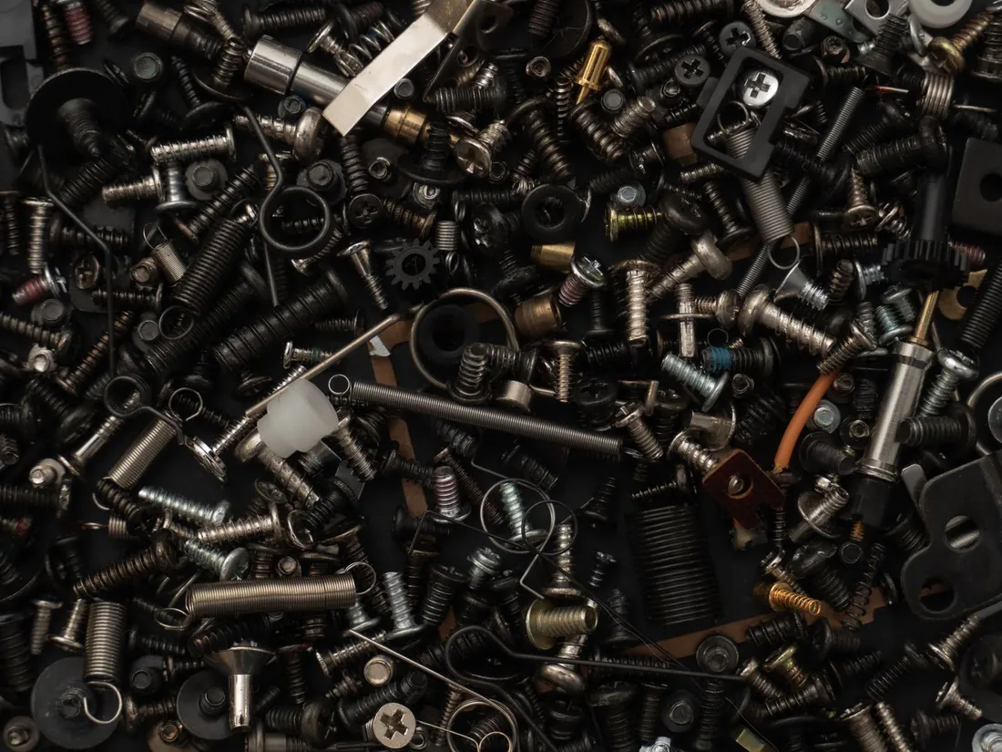 A pile of assorted metal springs, fasteners and formed components