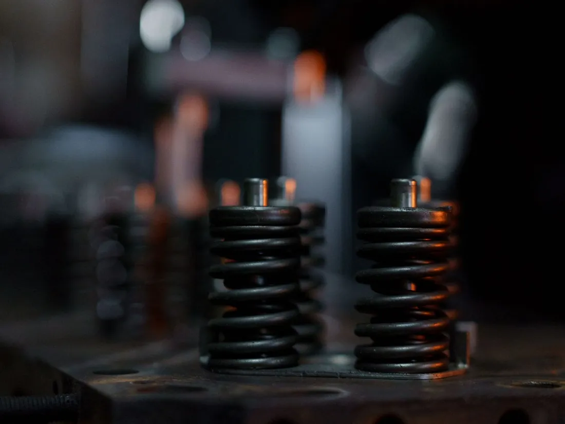 Steel valve springs standing on an engine cylinder head