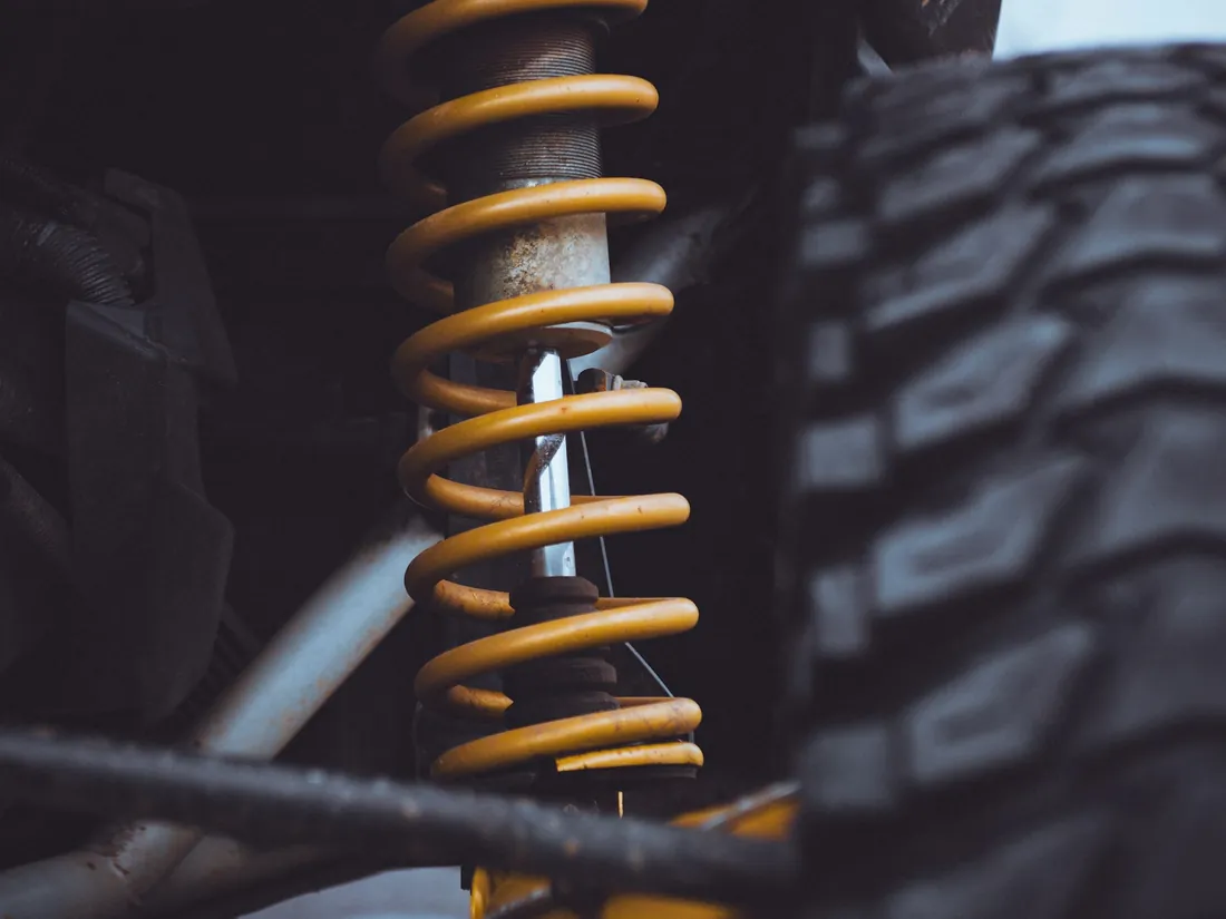 A heavy duty compression spring on a vehicle suspension strut