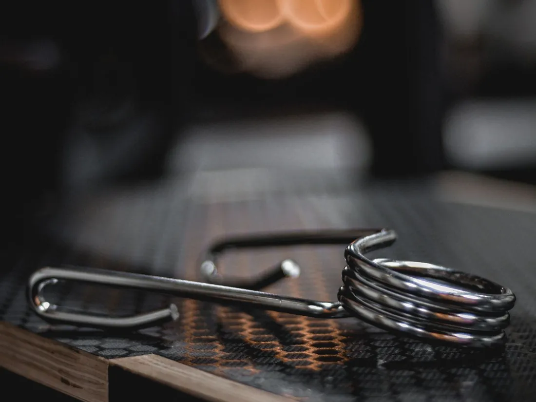 A torsion spring with a coiled body and two straight legs
