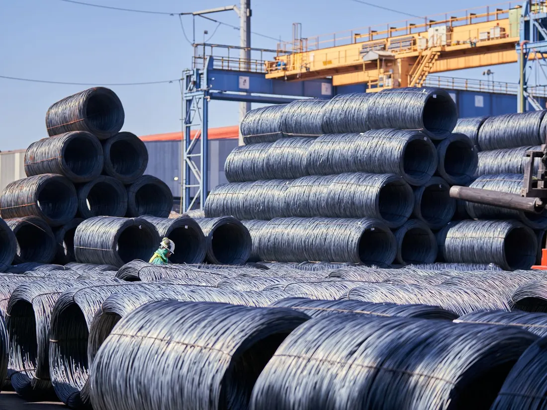 Stacks of steel wire rod coils at an industrial supply yard
