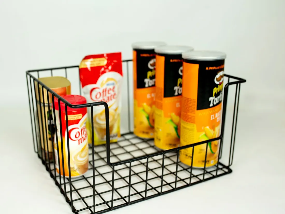 A wire display basket holding packaged retail goods