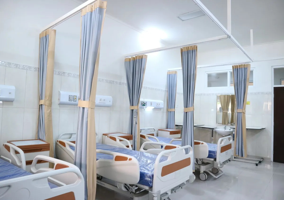 Hospital beds with steel frames in a ward