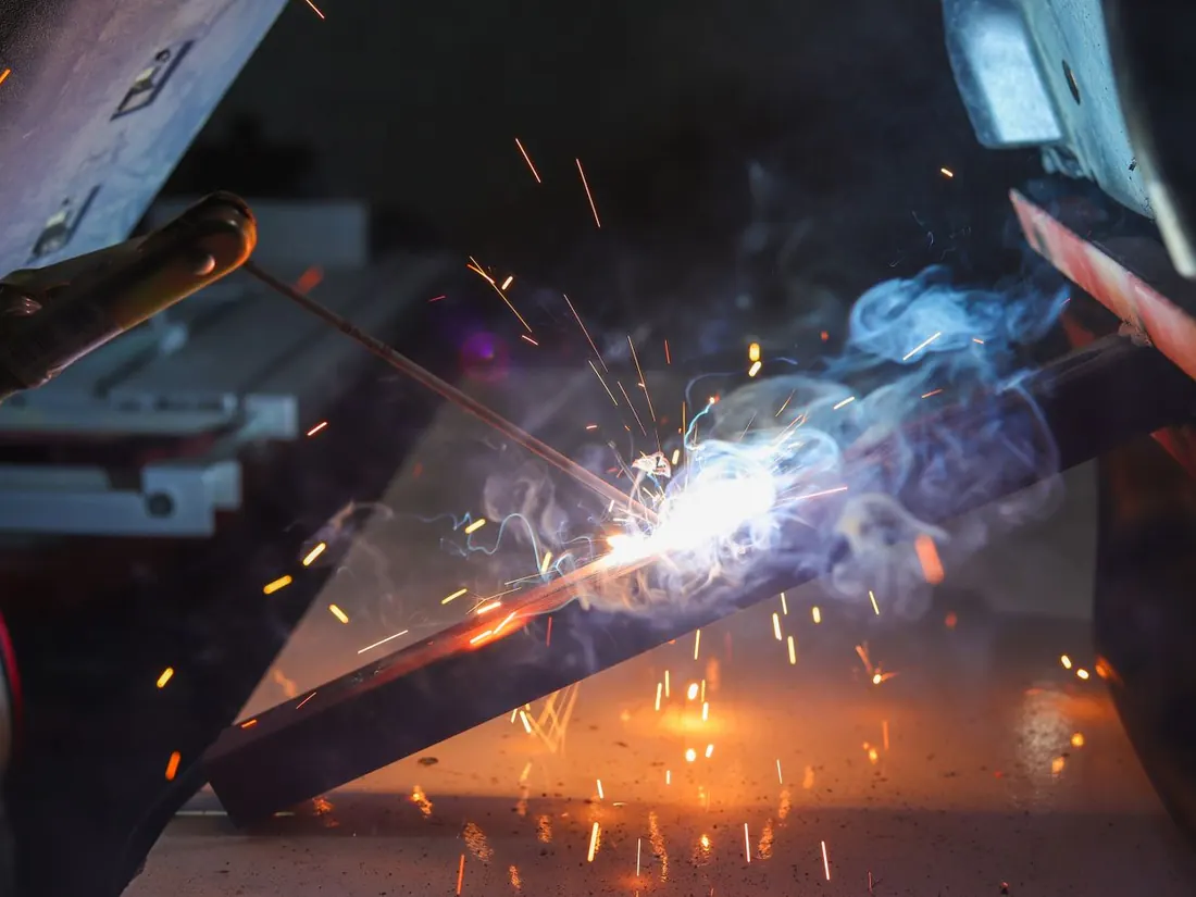 MIG welding throwing sparks in a workshop