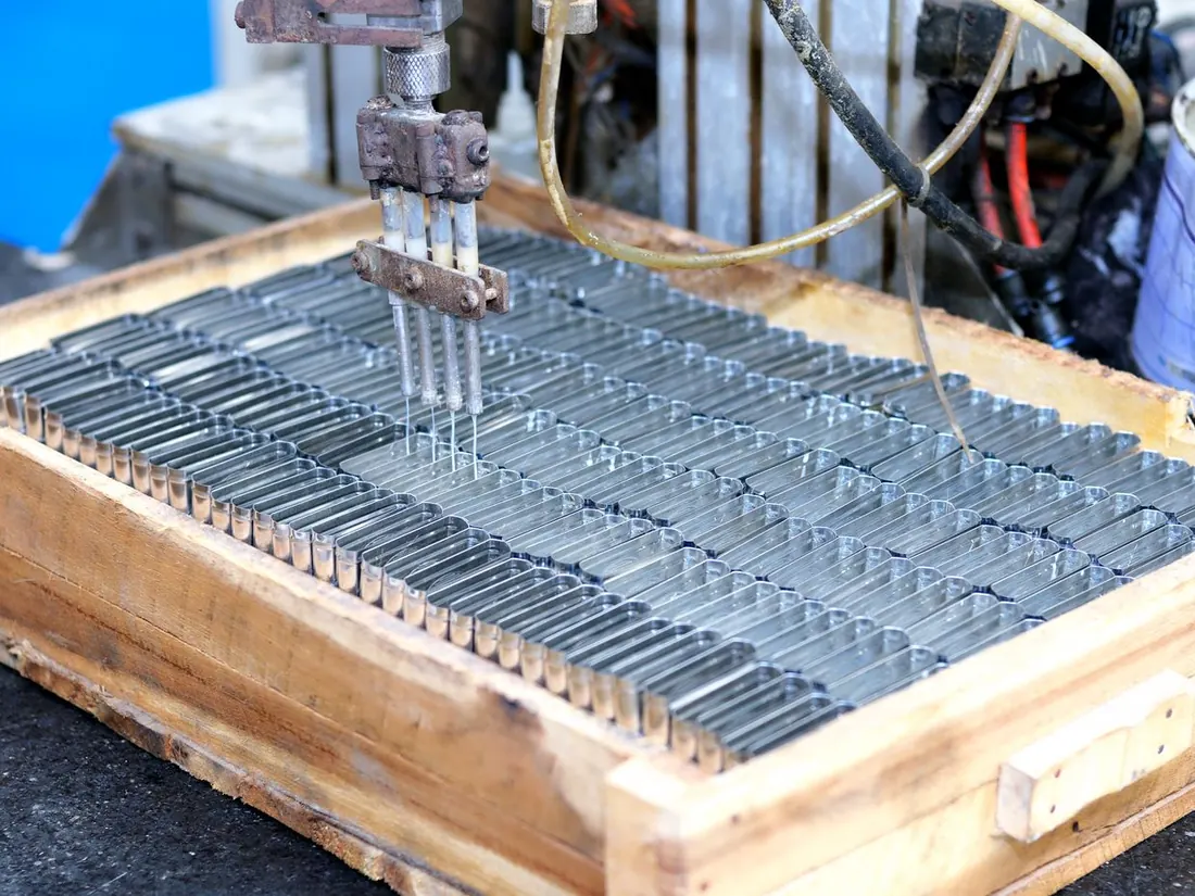 Machined metal components on a production jig