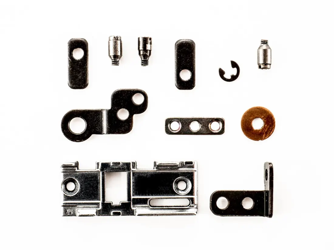 Pressed steel brackets and fixings on a white background